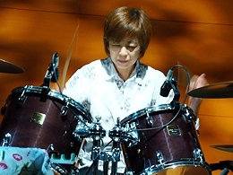 ドラムを演奏する峰村さん