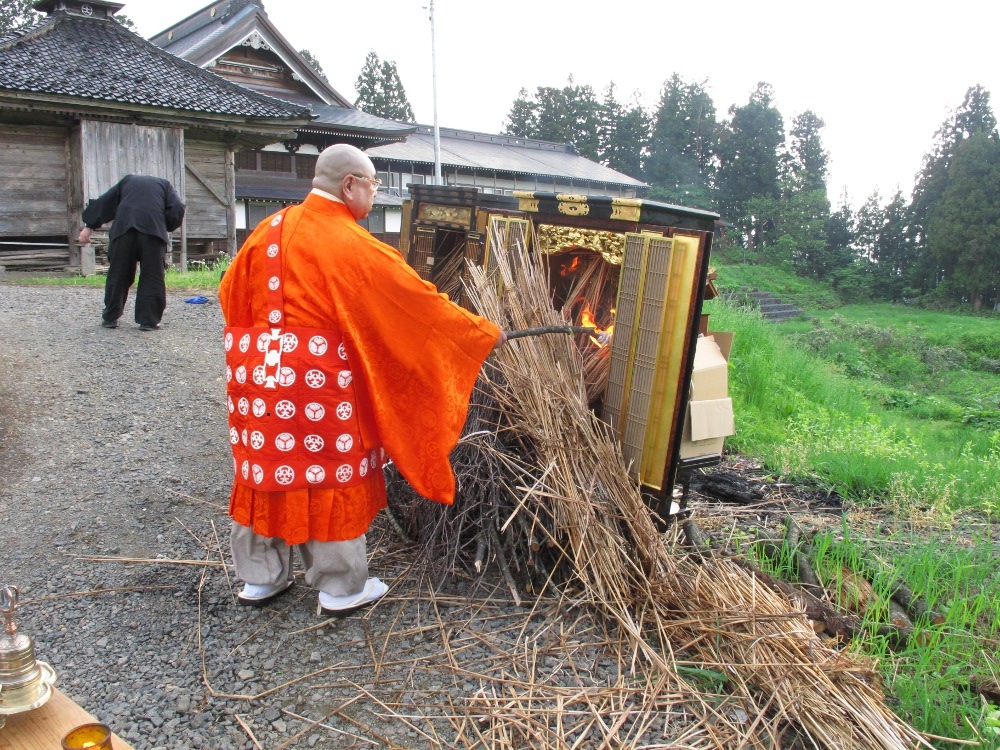 住職自らの手によりお焚き上げの品々に火を付けます